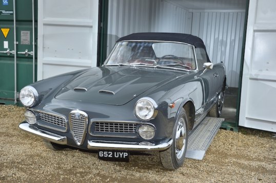 Vintage car driving out of container 