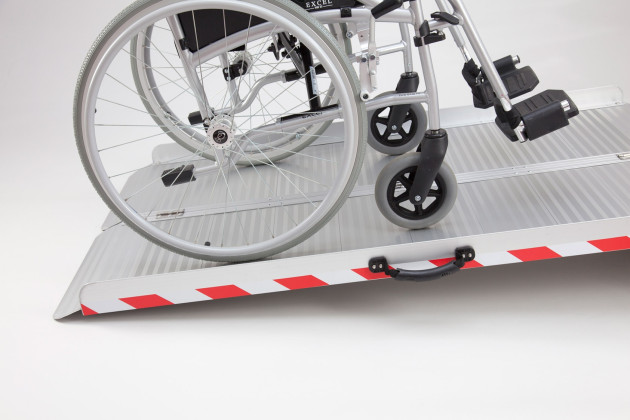 Manual wheelchair on extra wide folding wheelchair ramp