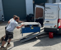 Pair of aluminium channel ramps loading into van 