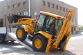 JCB driving up heavy duty loading ramps 