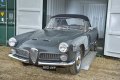 Classic car driving out of container on car ramps
