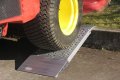 Aluminium container ramp resting on kerb 