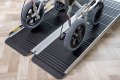 Wheelchair going up folding wheelchair ramp