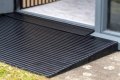 Rubber threshold ramp used with door sill guard on uPvc doorway 