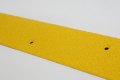 Yellow non-slip metal stair tread with grit coating