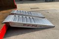 Pair of aluminium container ramps resting on container 