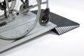 Manual wheelchair going over combination ramps