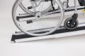 Wheelchair going up a pair of aluminium channel ramps  