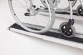 Wheelchair going up pair of telescopic wheelchair ramps 