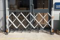 Expandable barrier outside front doors 