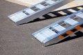 Pair of loading ramps resting on ground 