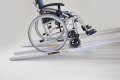 pair of telescopic wheelchair ramps with manual wheelchair going up the ramps