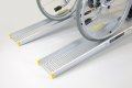Manual wheelchair on a pair of aluminium wheelchair ramps