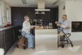Two people using Saljol indoor rollator in the kitchen