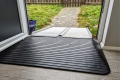 Portable wheelchair ramp paired with a rubber ramp to create a bridge over a door threshold