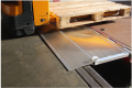 hinged tailboard with pallet truck driving over 