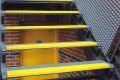 Yellow stair treads on metal staircase