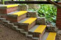 Yellow non-slip stair treads with nosing on concrete steps