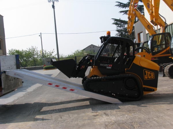 Loader driving on to loading ramps