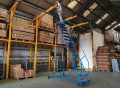 Mobile ladder in use in warehouse