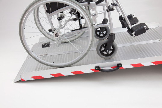 Manual wheelchair on extra wide folding wheelchair ramp