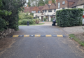75mm high speed bumps fixed across a private road, alternating black and yellow in colour