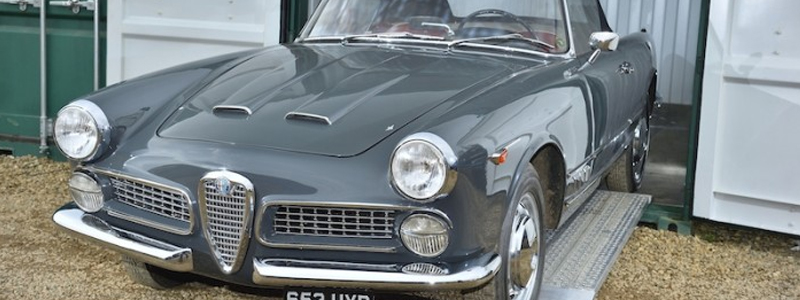 Grey classic car on loading ramps 