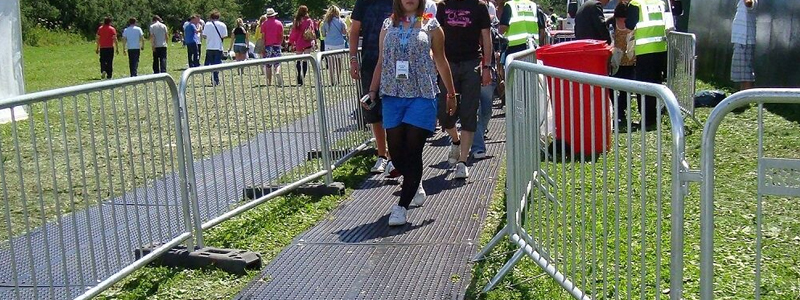 People walking on ground protection mats