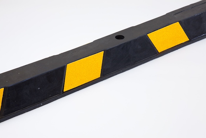 Black and yellow rubber wheel stops