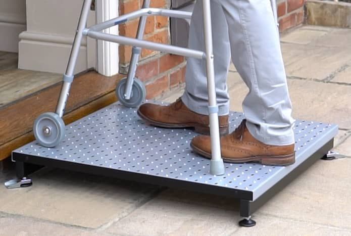 Zimmer frame on adjustable half step outside front door 