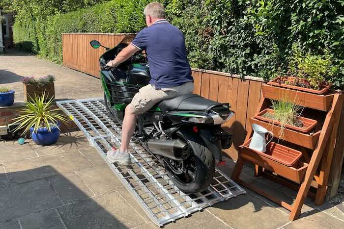 Man sat on bike going up motorcycle ramps 