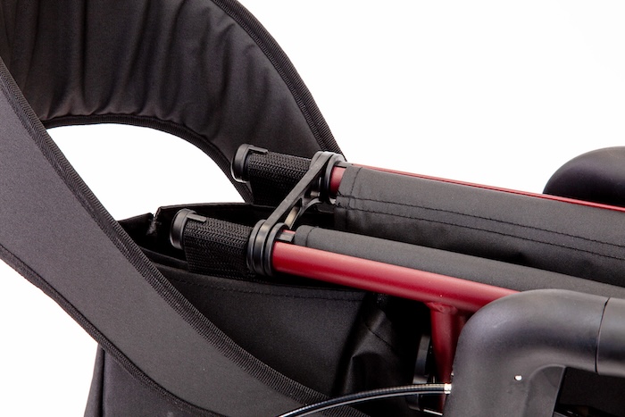 Folded rollator clipped shut when stored