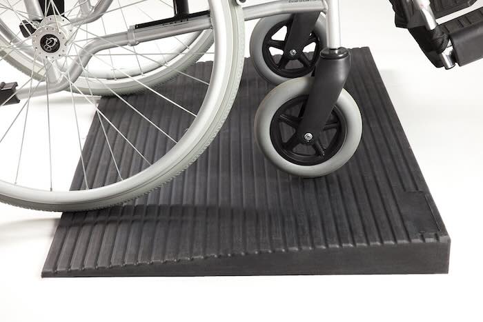 Manual wheelchair on threshold ramp 