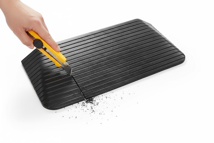 Rubber ramp being cut to size Rubber ramp being cut to size