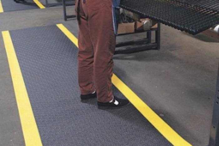 Worker stood on anti-fatigue mat