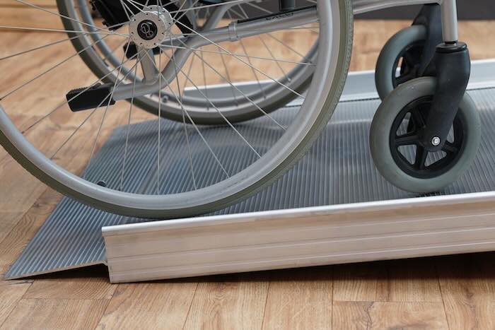Wheelchair on aluminium ramp
