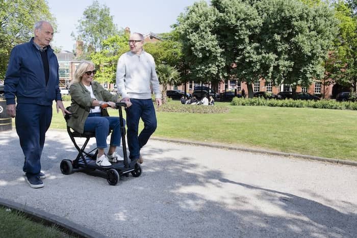Lady sat on mobility scooter in park 