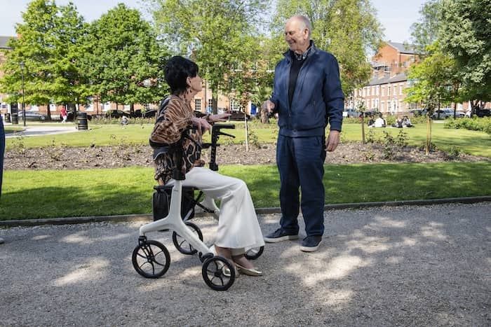 Lady sat on rollator in park 