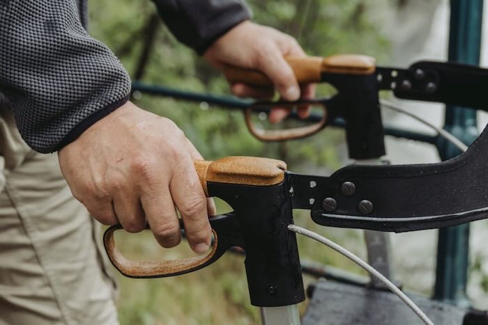 Man pushing shock-absorbant handles on rollator