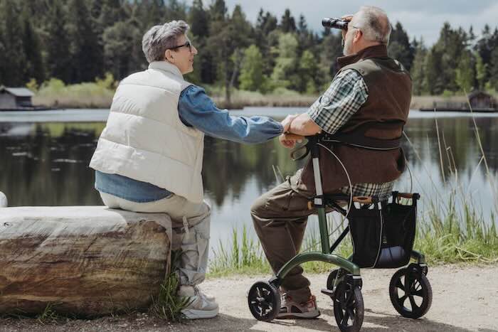 Lady and man sat by lake, man sat on green  Saljol Allround Rollator