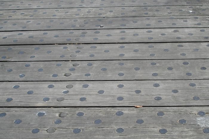 Black anti-slip discs on walkway