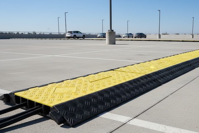 Heavy duty cable protectors in car park Heavy duty cable protectors in car park
