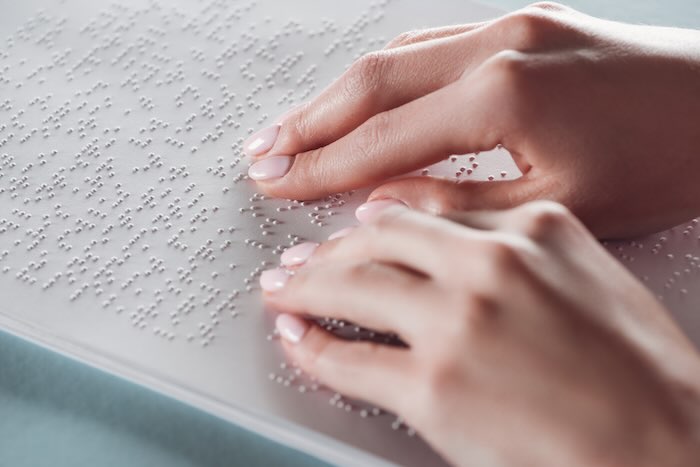 Person reading brail 
