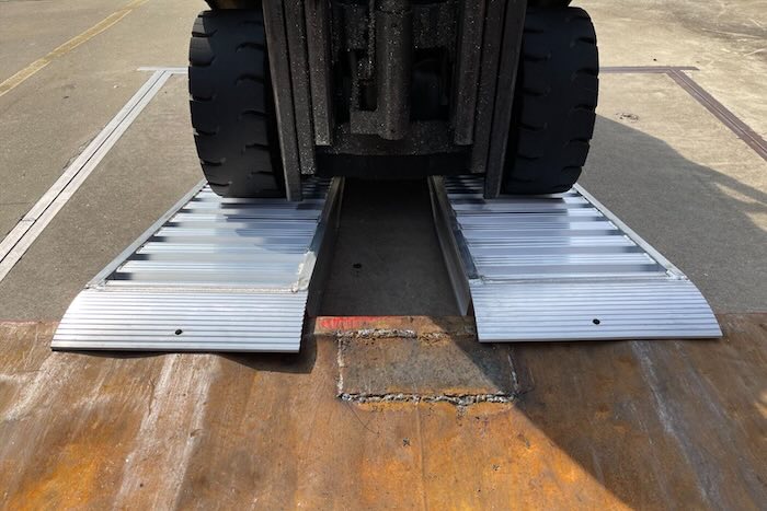 Container ramp resting on step 