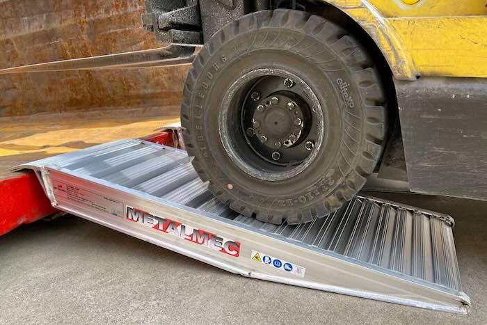 Container ramp resting on step Container ramp resting on step