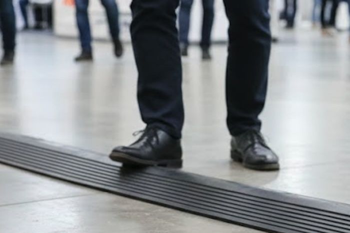 Person walking over black cable protector
