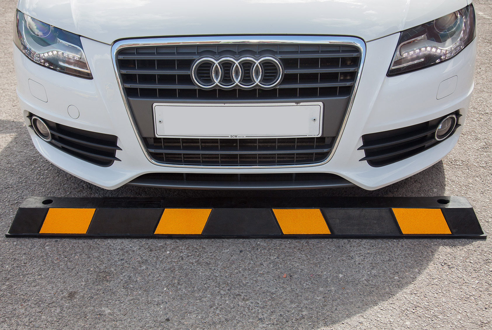 Black and yellow EV charging point protector - rubber wheel stop Black and yellow EV charging point protector - rubber wheel stop