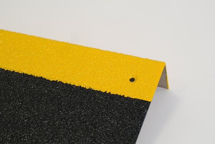 Black and yellow stair tread with anti-slip surface