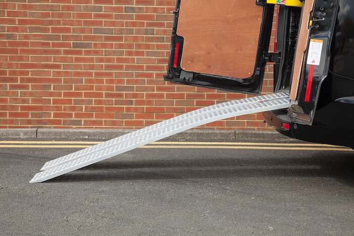 Curved aluminium van ramps resting on van Curved aluminium van ramps resting on van