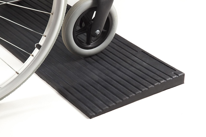 Manual wheelchair on threshold ramp 